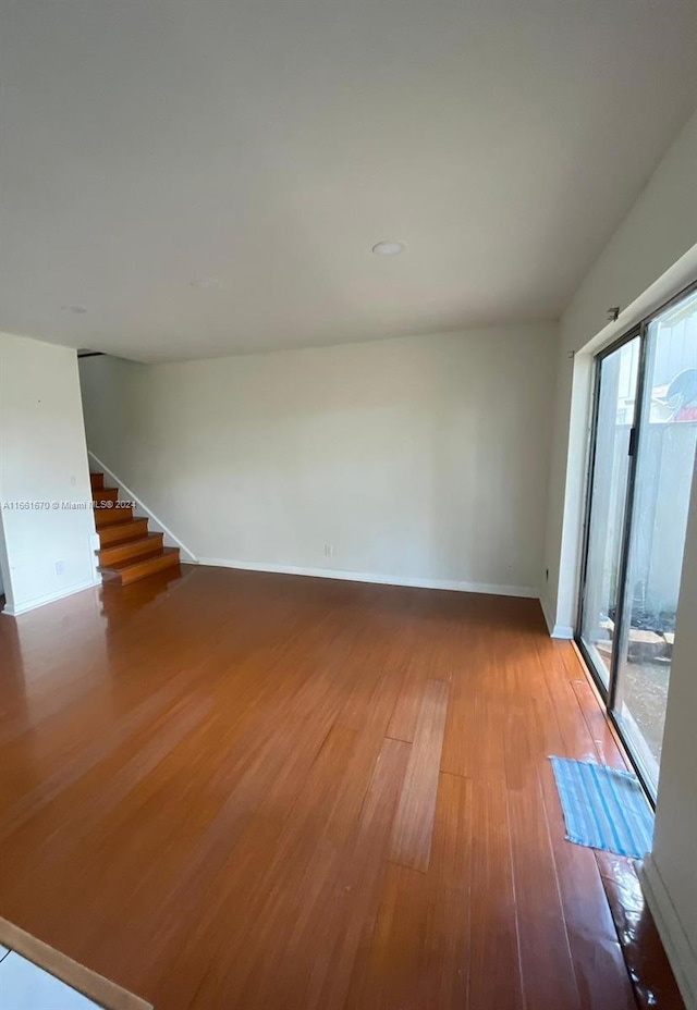 unfurnished room featuring hardwood / wood-style floors and plenty of natural light