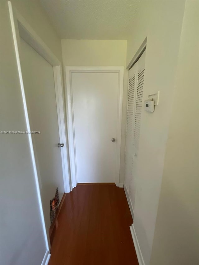 corridor with dark wood-type flooring