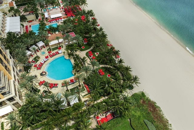 drone / aerial view featuring a beach view and a water view