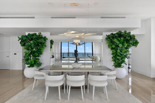 dining space featuring light wood-type flooring and a notable chandelier