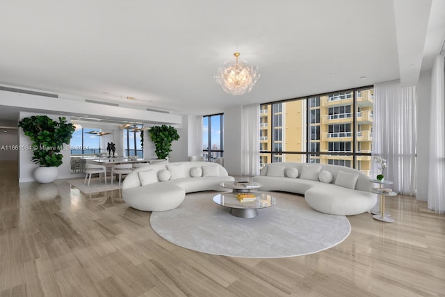 living room featuring a notable chandelier and light hardwood / wood-style flooring