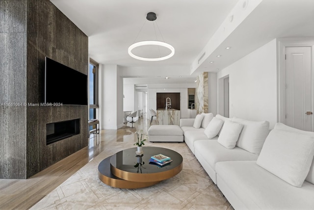 living room with a fireplace and light hardwood / wood-style flooring