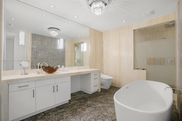 full bathroom featuring an inviting chandelier, separate shower and tub, vanity, and toilet