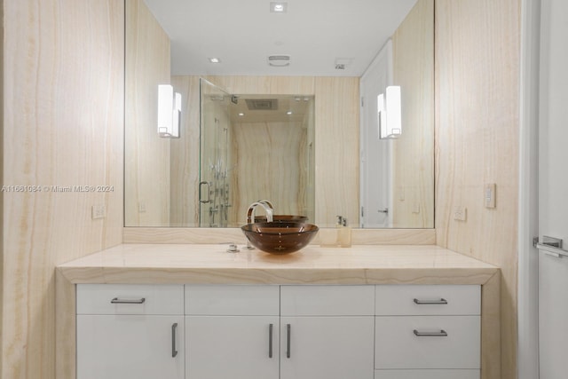 bathroom with vanity and a shower with door