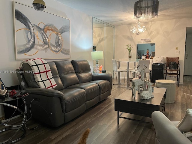 living room with wood-type flooring and an inviting chandelier