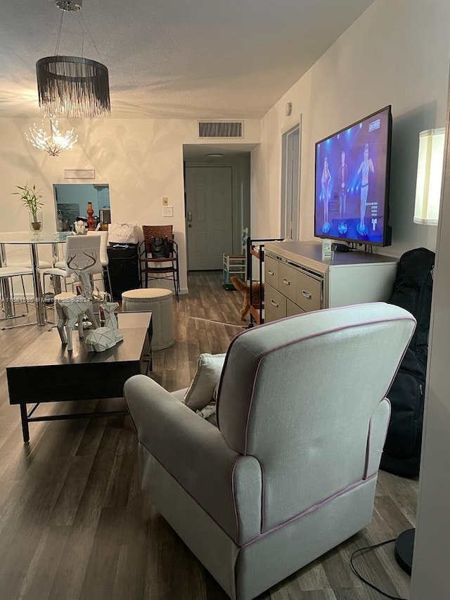 living room featuring an inviting chandelier and hardwood / wood-style flooring