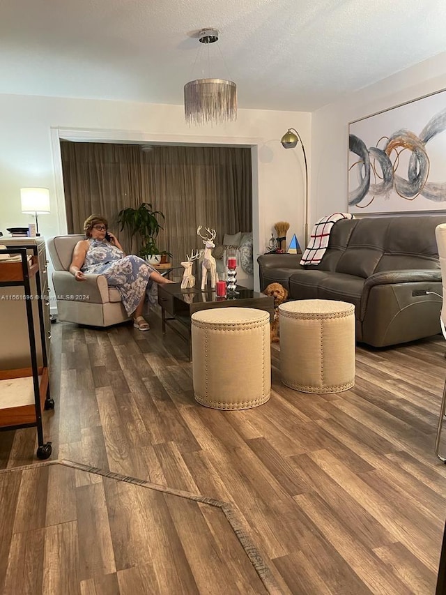 living room featuring a textured ceiling and hardwood / wood-style floors