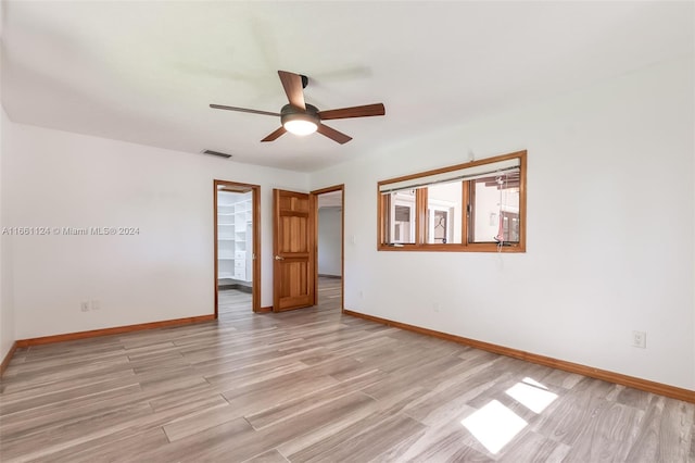 spare room featuring light wood-type flooring and ceiling fan