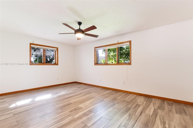 spare room featuring light hardwood / wood-style flooring and ceiling fan