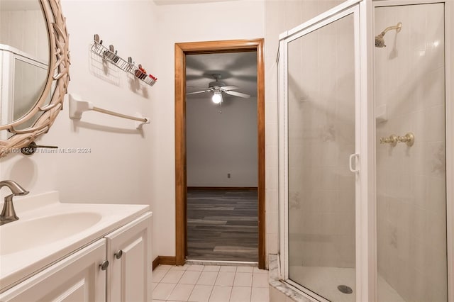 bathroom with ceiling fan, vanity, hardwood / wood-style floors, and an enclosed shower