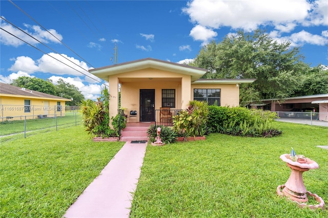 view of front of property with a carport, covered porch, and a front yard