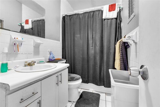 full bathroom featuring tile walls, tile patterned flooring, shower / tub combo, vanity, and toilet