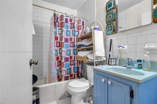 full bathroom with tile walls, vanity, toilet, and shower / bath combo with shower curtain