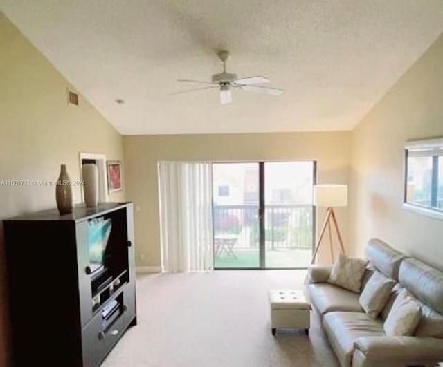 living room with ceiling fan, vaulted ceiling, carpet, and a healthy amount of sunlight