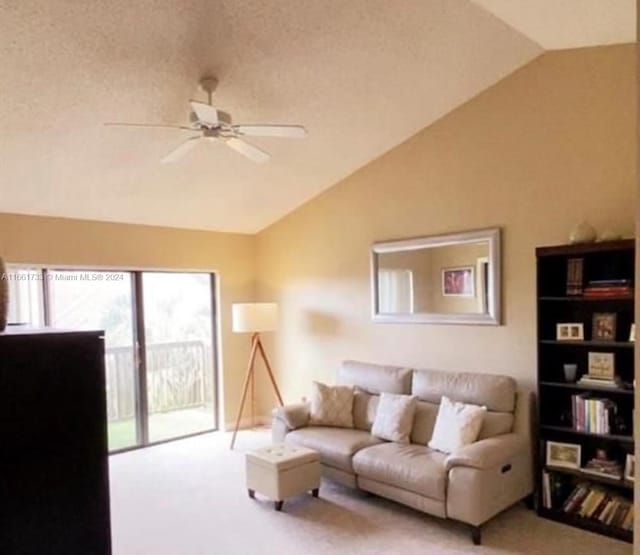 carpeted living room featuring ceiling fan, a textured ceiling, and lofted ceiling