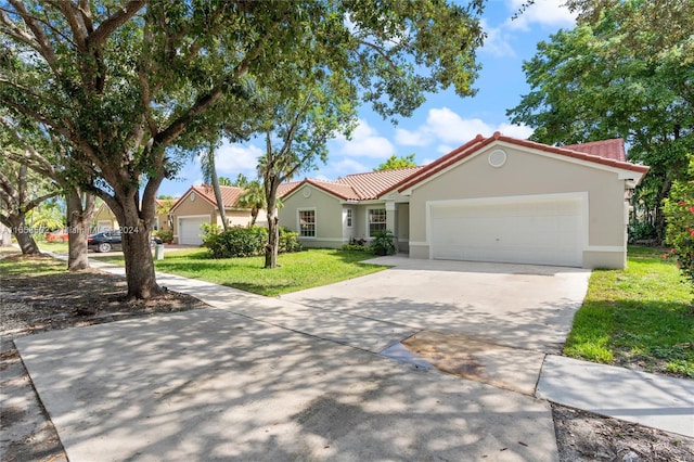 view of front facade with a garage and a front lawn