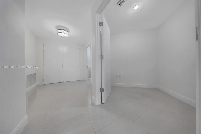 hall featuring light tile patterned floors