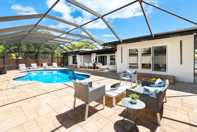 view of pool featuring a lanai, outdoor lounge area, and a patio area