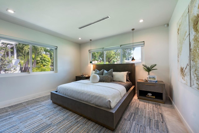 tiled bedroom featuring multiple windows