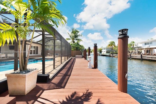 dock area featuring glass enclosure and a water view