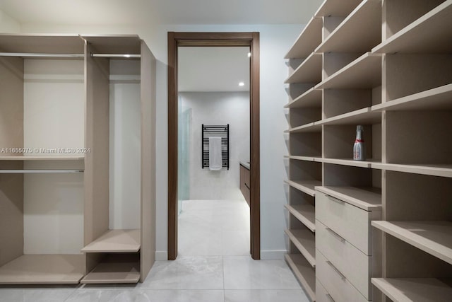 spacious closet featuring light tile patterned floors
