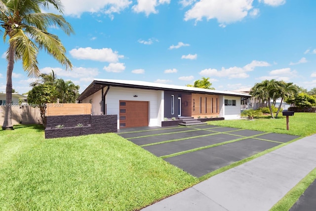single story home with a front yard and a garage