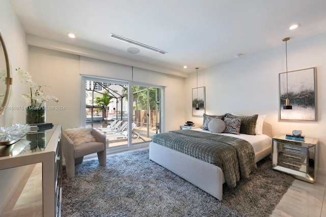bedroom with access to outside and hardwood / wood-style flooring