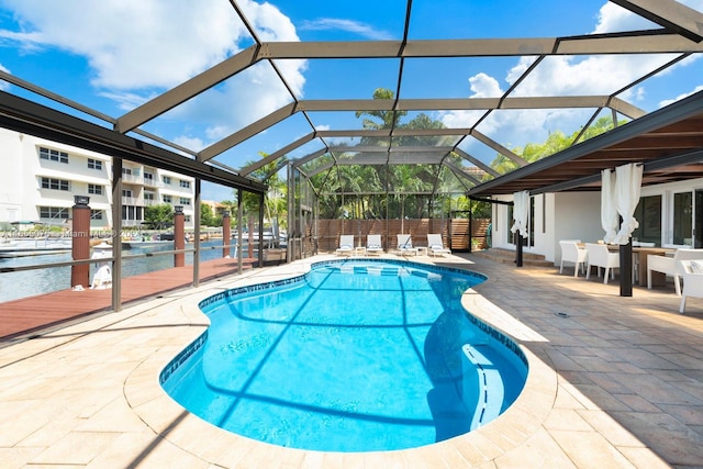 view of swimming pool with a lanai and a patio area