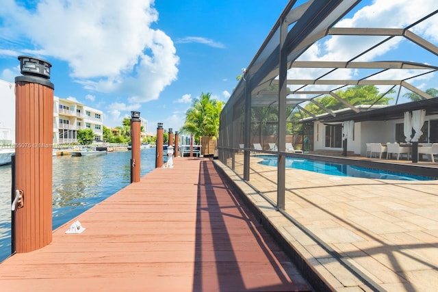 view of dock featuring a lanai, a patio area, and a water view