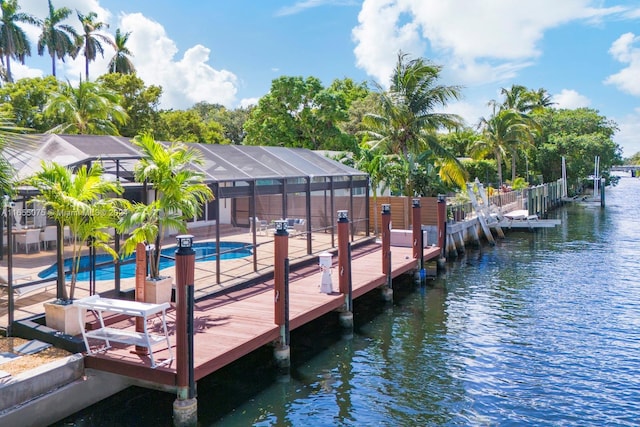 view of dock featuring a patio area, a lanai, a fenced in pool, and a water view