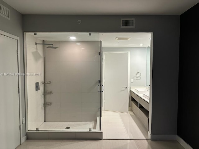 bathroom with tile patterned floors, walk in shower, and vanity