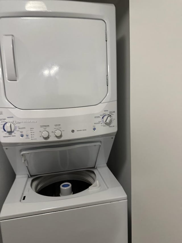 clothes washing area with stacked washer and clothes dryer