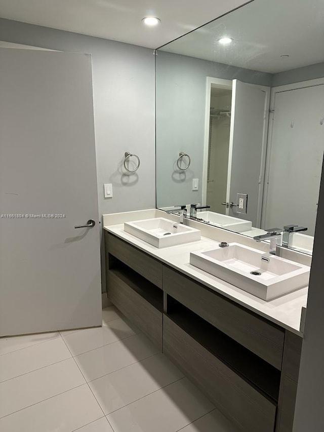 bathroom featuring tile patterned flooring and vanity