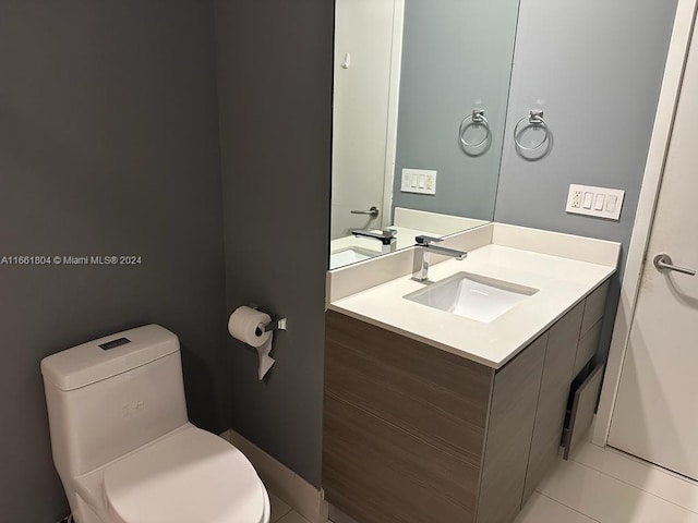 bathroom featuring tile patterned floors, vanity, and toilet