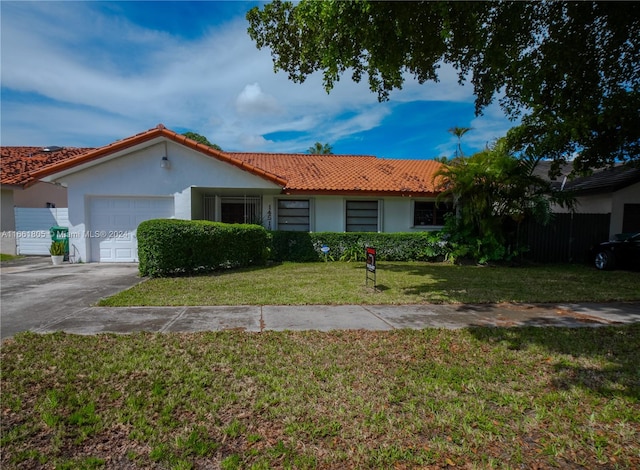 ranch-style house with a front yard and a garage