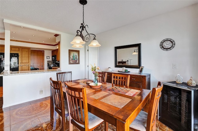 dining area featuring a textured ceiling, tile patterned flooring, and beverage cooler