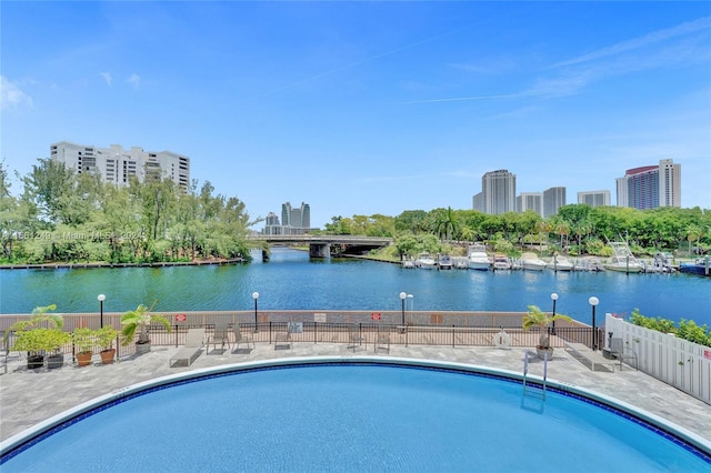 view of swimming pool with a water view