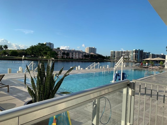 view of swimming pool featuring a water view