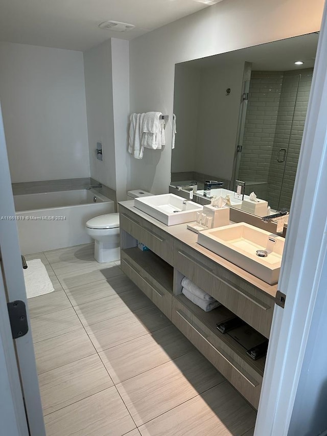 full bathroom featuring vanity, shower with separate bathtub, and toilet