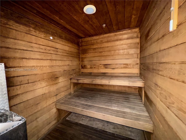 view of sauna with wood walls and wooden ceiling