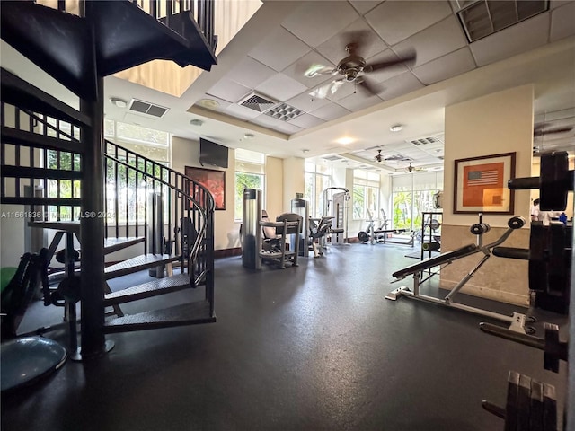 workout area featuring a paneled ceiling and ceiling fan