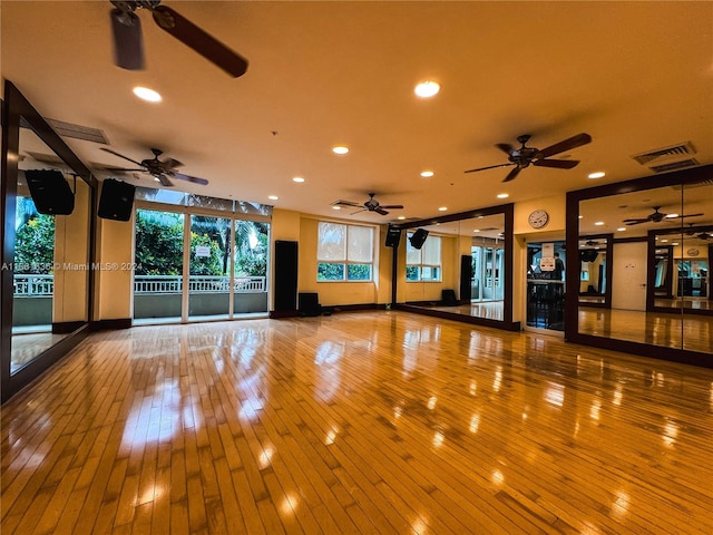 exercise area featuring ceiling fan and hardwood / wood-style floors