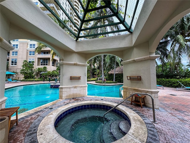 view of swimming pool with a patio and a community hot tub