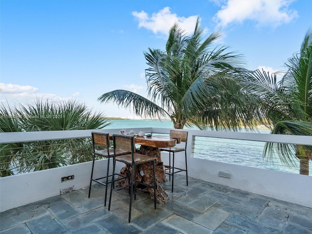 view of patio / terrace with a bar and a water view