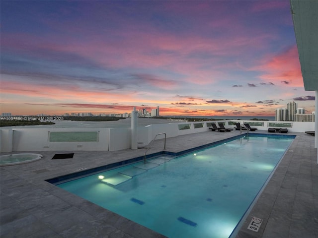 pool at dusk with a patio