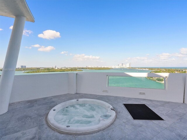 view of patio / terrace featuring an in ground hot tub