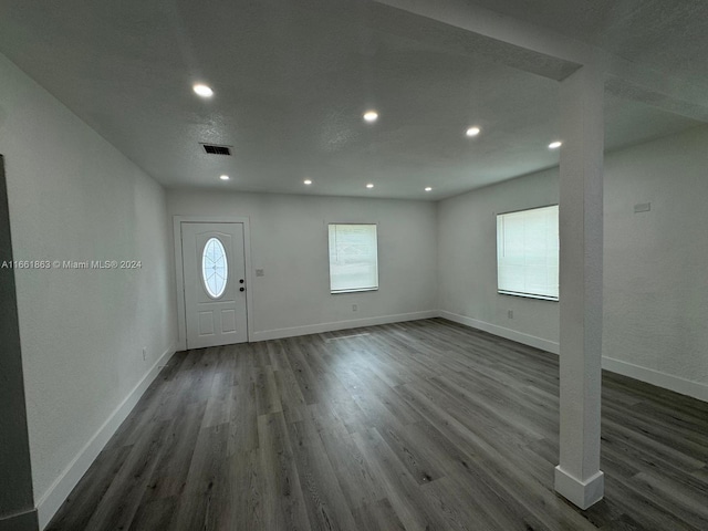 foyer entrance featuring a textured ceiling and dark hardwood / wood-style flooring