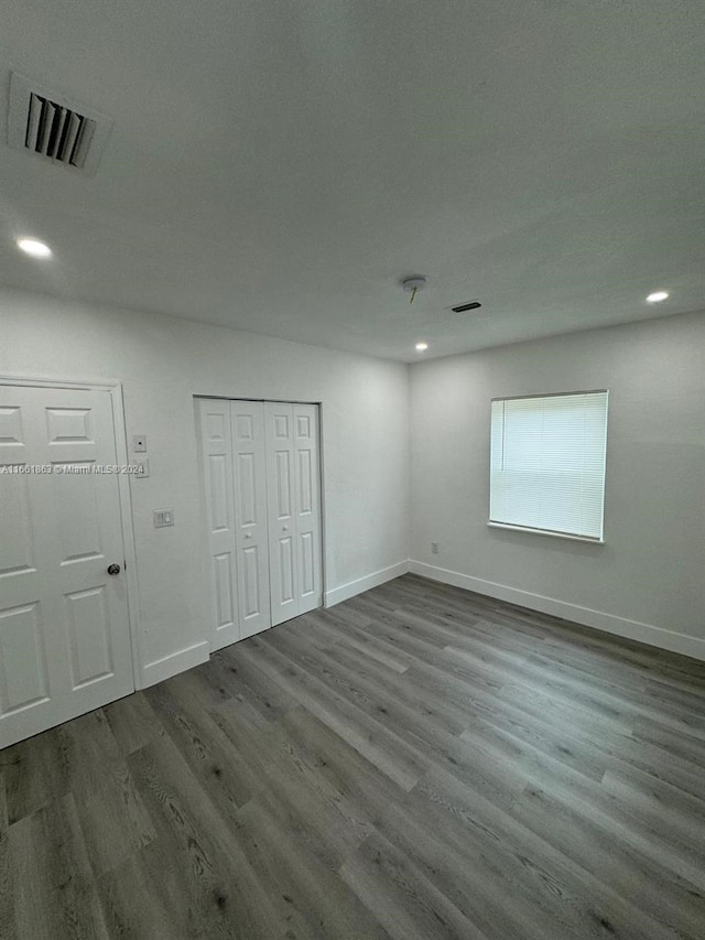 unfurnished room with wood-type flooring