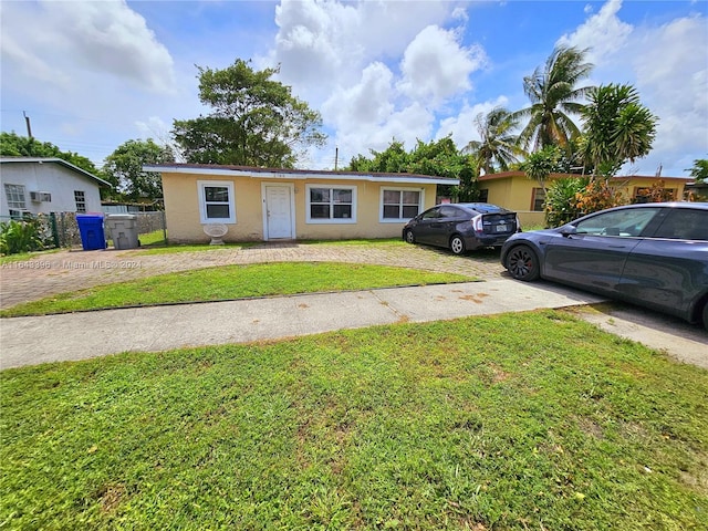 ranch-style house with a front lawn