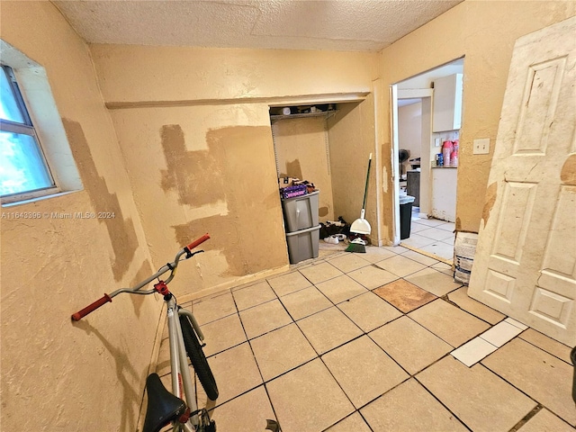 bathroom featuring a textured ceiling and tile patterned floors